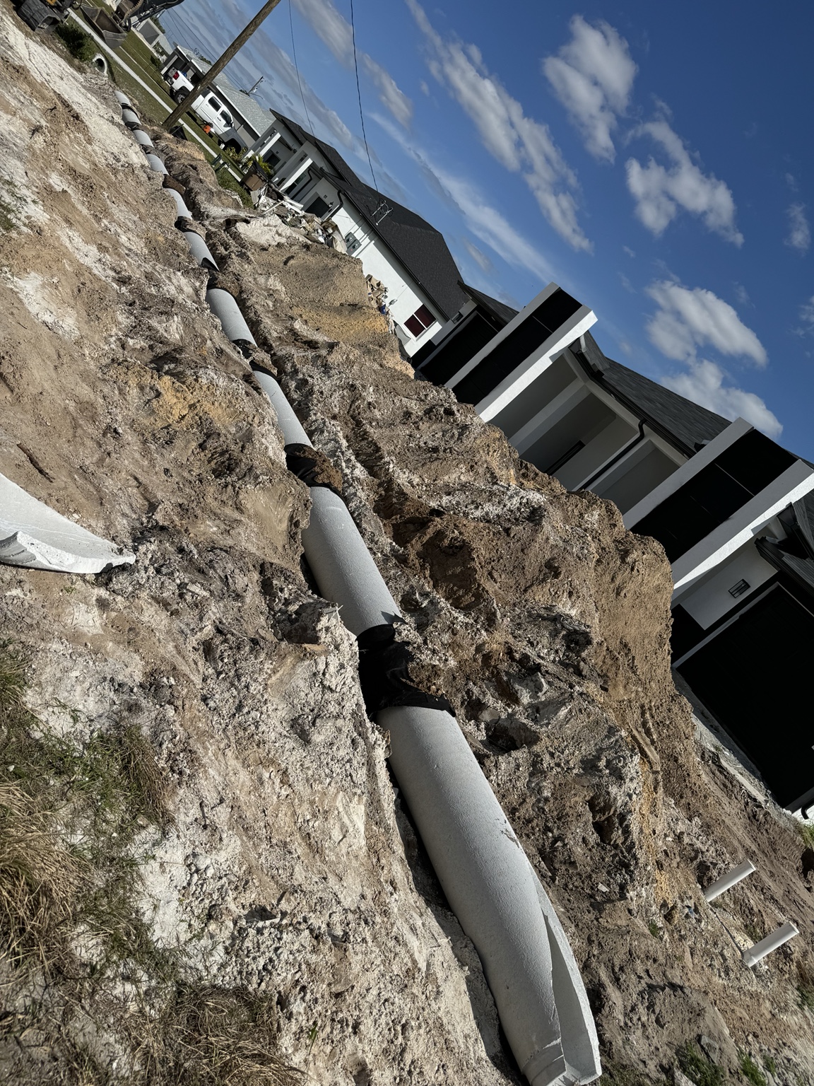 Drainage pipe installation beside new homes